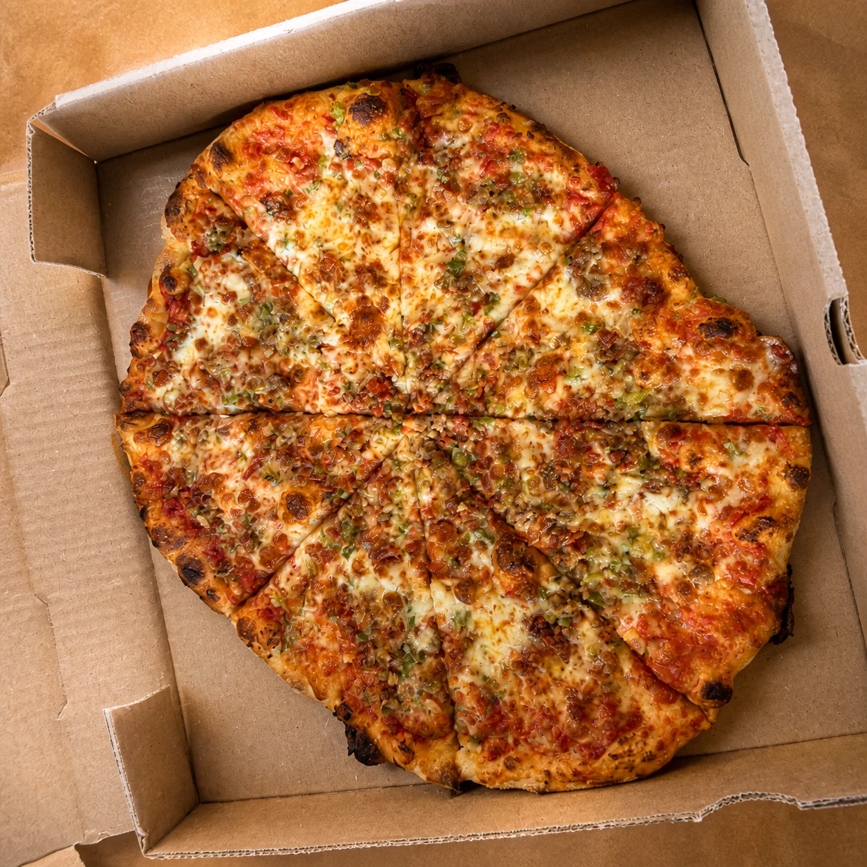 Tony’s supreme pizza with finely chopped toppings in its box